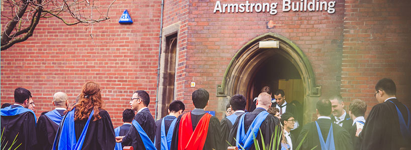 Graduates outside Armstrong Building