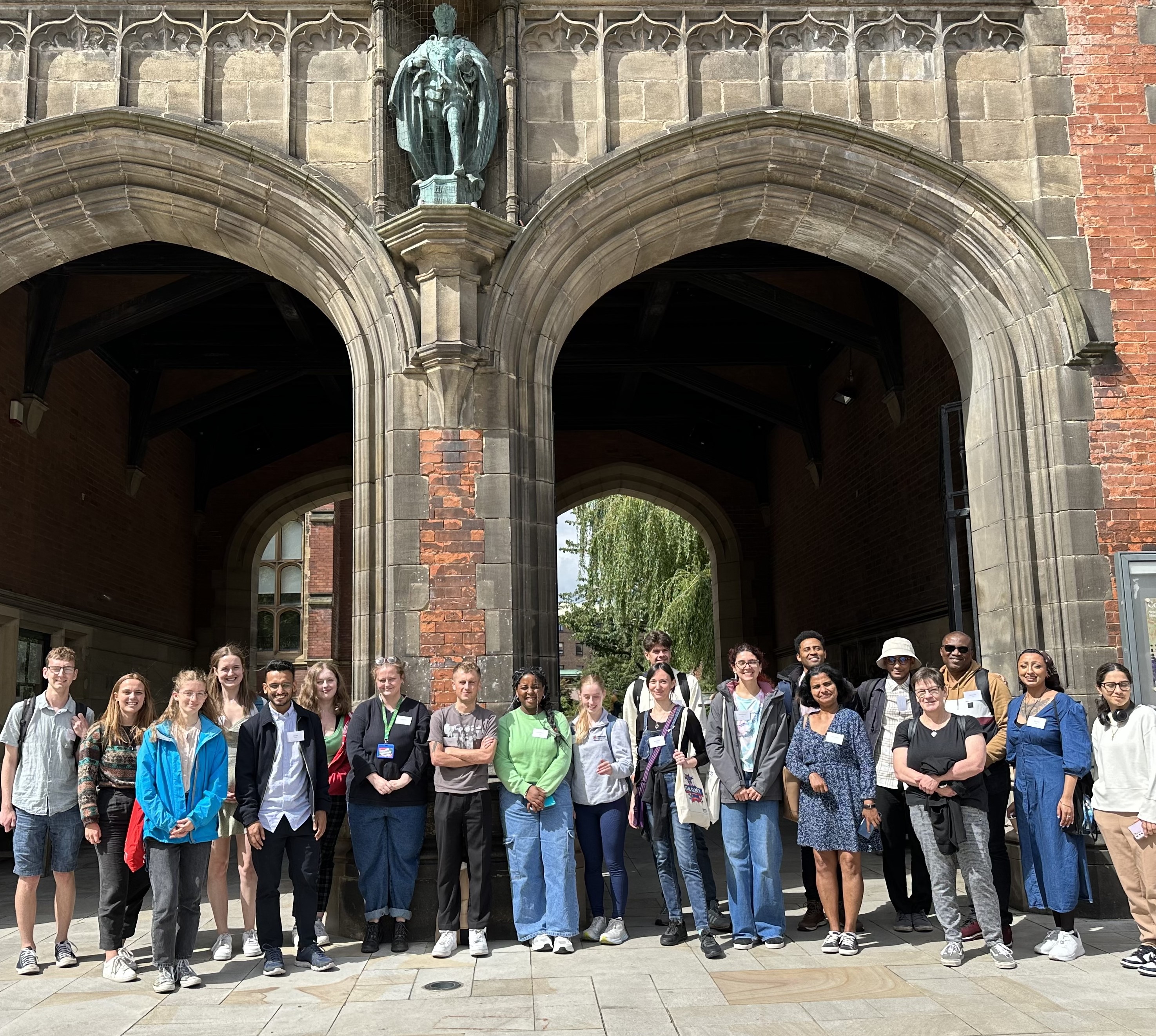 Participants standing in front of arches